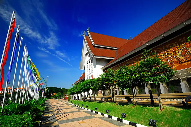 Malaysia National Museum in Kuala Lumpur with flags and a clear blue sky.
