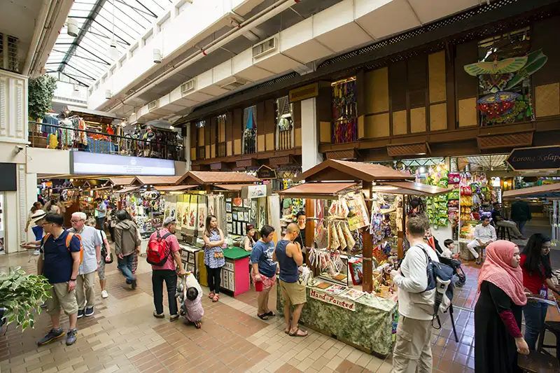Tourists exploring the vibrant stalls at Central Market Kuala Lumpur, a cultural shopping hub in Malaysia.