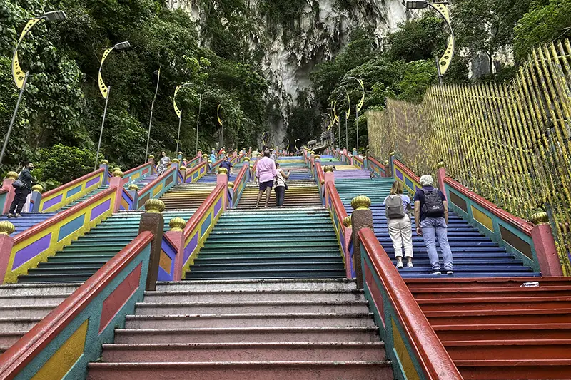Rainbow-colored steps leading to Batu Caves in Kuala Lumpur, a free and iconic tourist attraction in Malaysia.