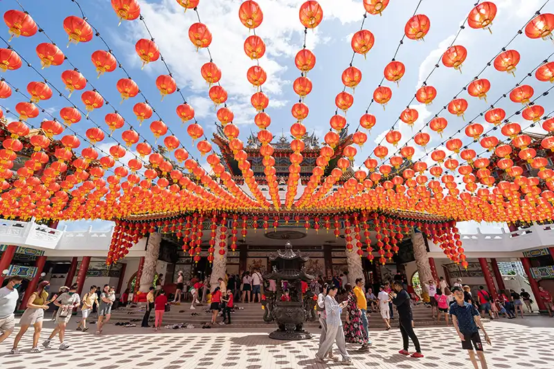 Thean Hou Temple in Kuala Lumpur decorated with vibrant red lanterns during the day.