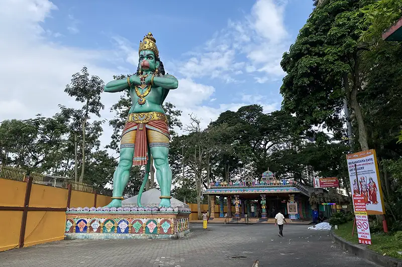 The towering green Hanuman statue at Batu Caves in Kuala Lumpur, marking the entrance to the Ramayana Cave.