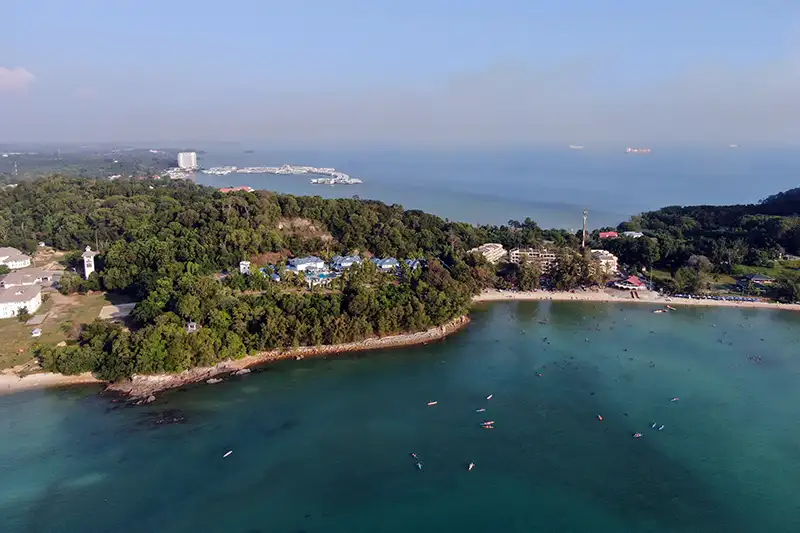 Aerial view of Port Dickson beach with clear waters and coastal greenery.