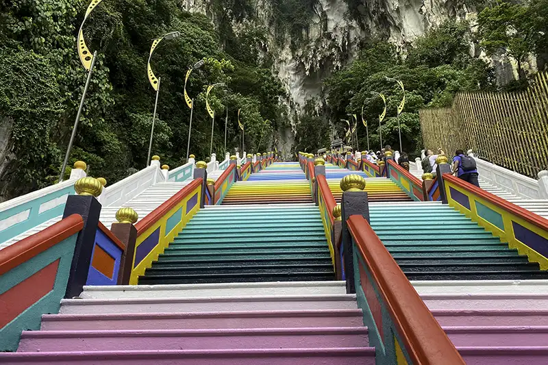 The 272 steps at Batu Caves in Kuala Lumpur during the repainting process in March 2023, featuring vibrant colors.