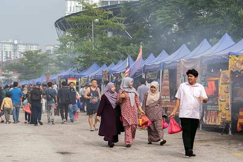 People shopping at a Bazaar Ramadan in Malaysia during the fasting month of Ramadan. The best time to visit Malaysia