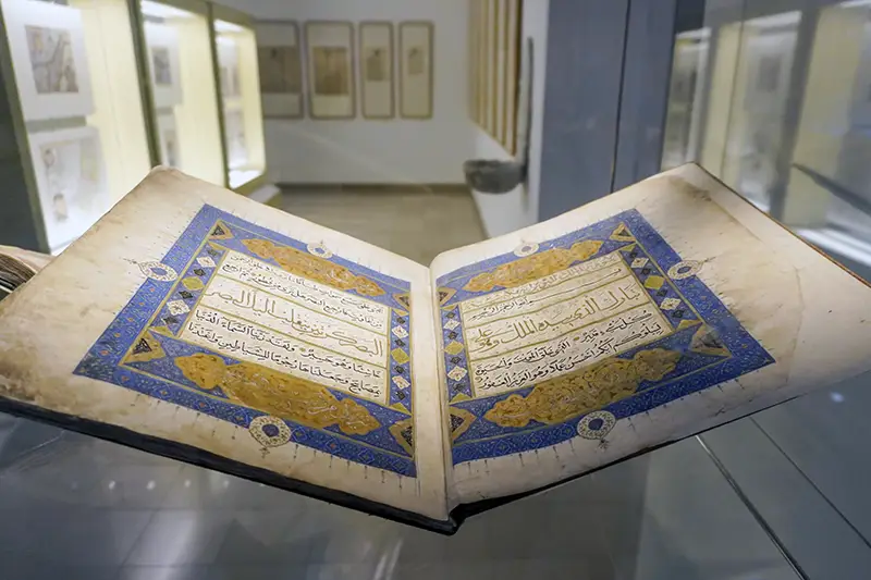 A beautifully illuminated Quran displayed at the Islamic Arts Museum, one of the most cultural and educational things to do in Kuala Lumpur.