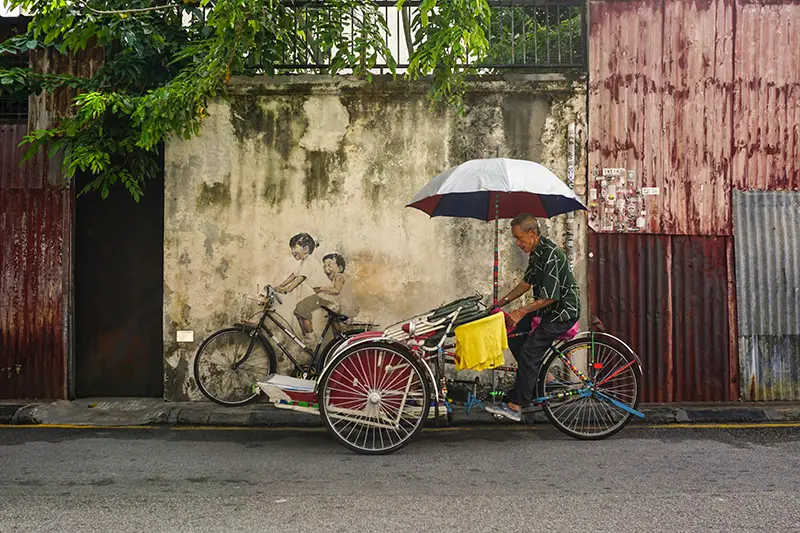 Street art mural and trishaw in George Town, Penang, a UNESCO World Heritage Site and popular place to visit in Malaysia"