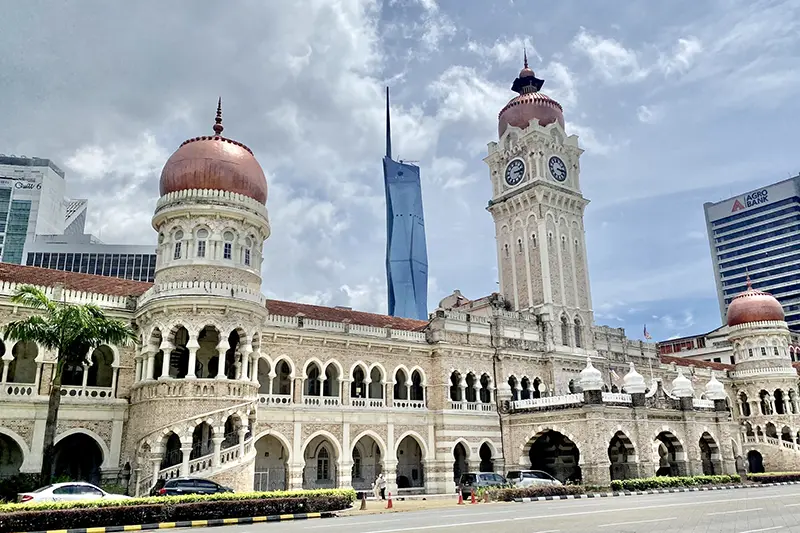 Sultan Abdul Samad Building at Merdeka Square in Kuala Lumpur with the modern Merdeka 118 tower in the background, showcasing the city's blend of history and modernity.