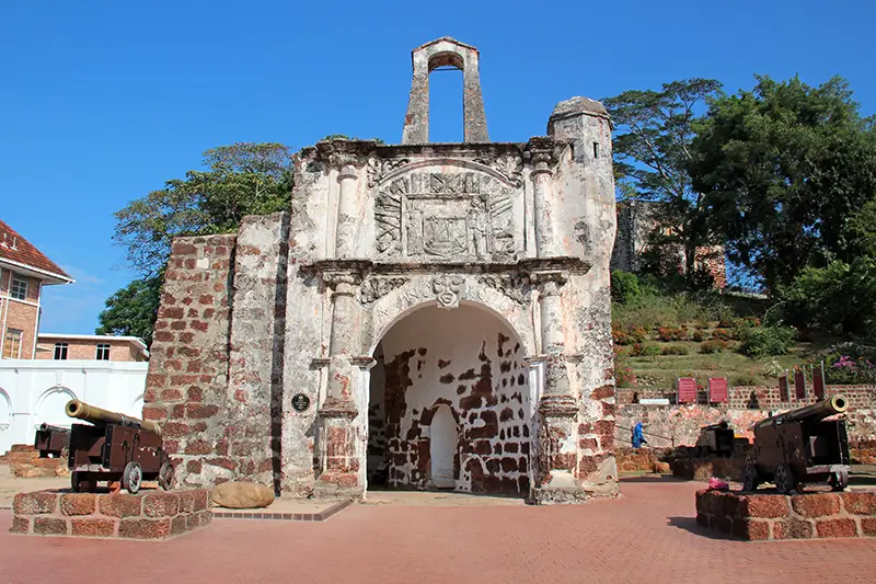 A Famosa fortress in Malacca, Malaysia, showcasing the historical Portuguese landmark with cannons and ancient stone walls.