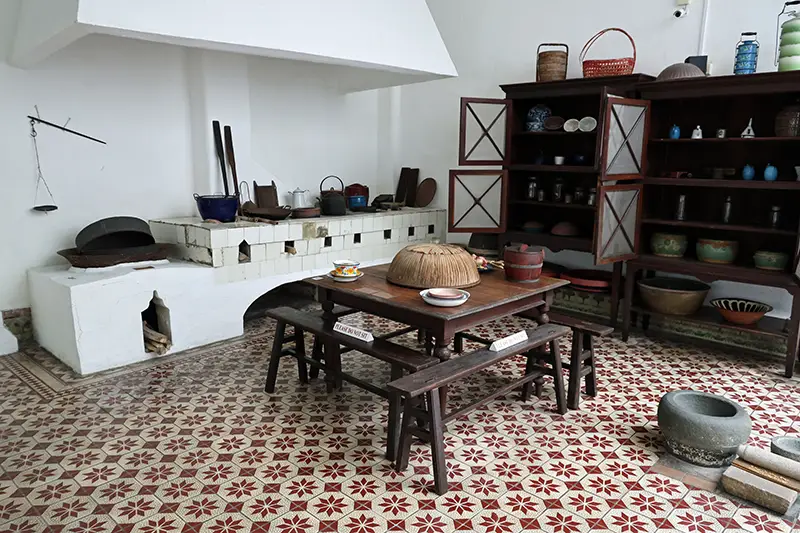 Traditional kitchen setup at the Baba Nyonya Heritage Museum in Malacca, showcasing Peranakan culture and history.