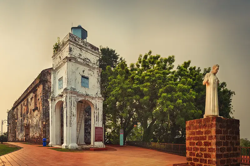 Saint Paul Church in Malacca, a historic site popular among tourists on a Malacca day tour, featuring ancient ruins and a statue of St. Francis Xavier