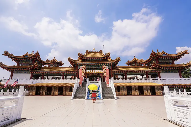 Tourist taking a photo in front of Thean Hou Temple, a must-visit cultural site featured in 2 days Kuala Lumpur itinerary