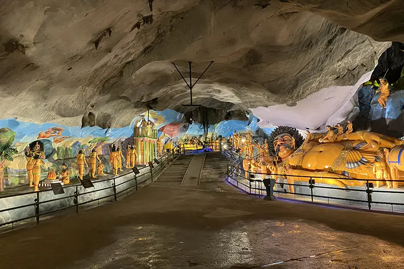 Colorful statues and giant sculpture inside Ramayana Cave at Batu Caves, Malaysia, depicting scenes from the Hindu epic Ramayana